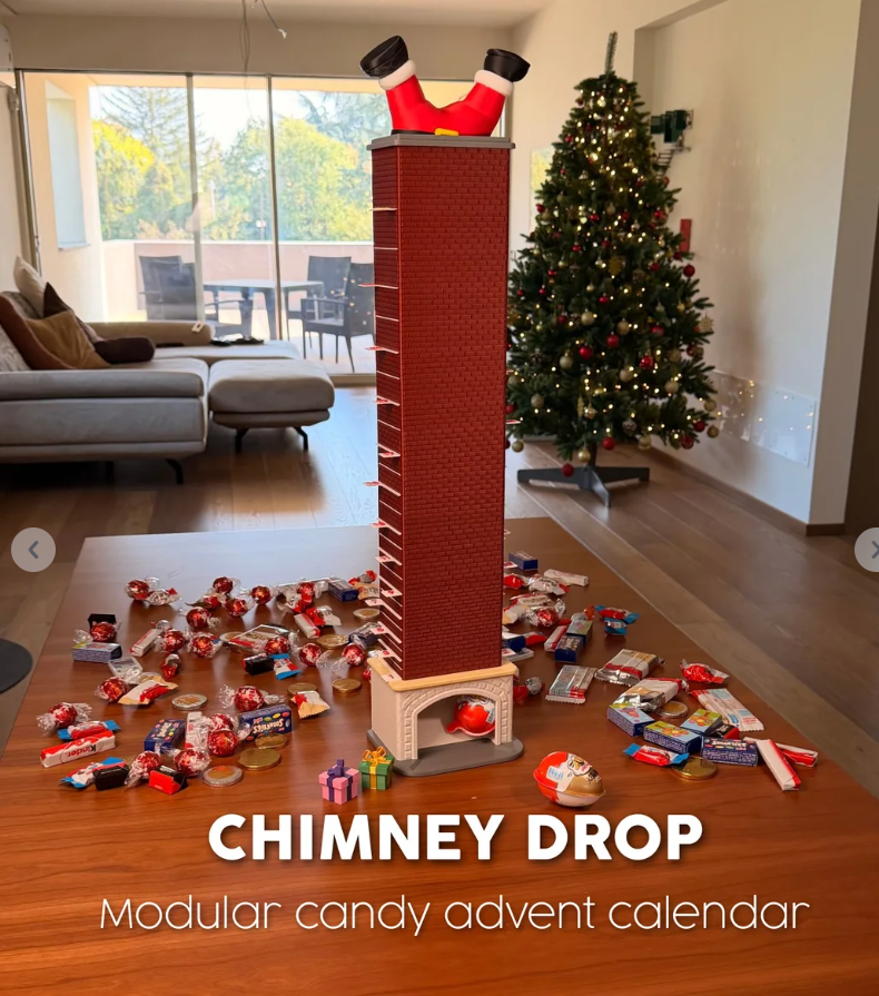 Tall red brick candy advent calendar with Santa's boots at the top and a fireplace opening at the bottom